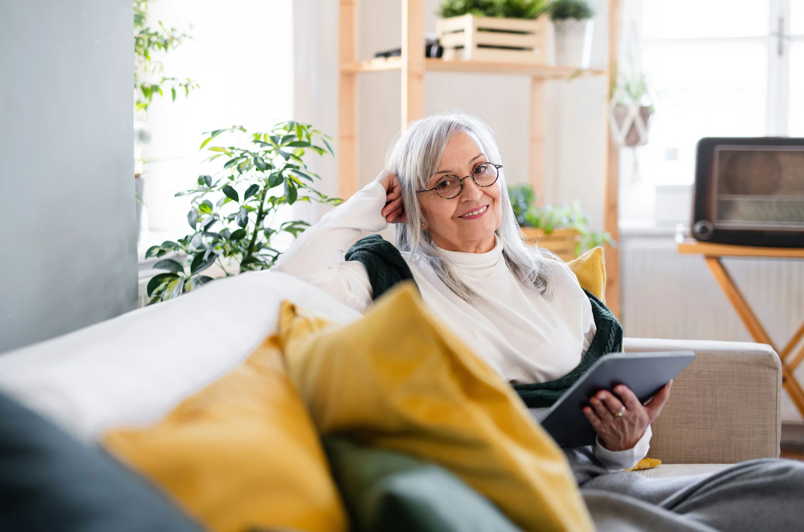 image of senior woman relaxing comfortably at home after professional house cleaning for seniors visit