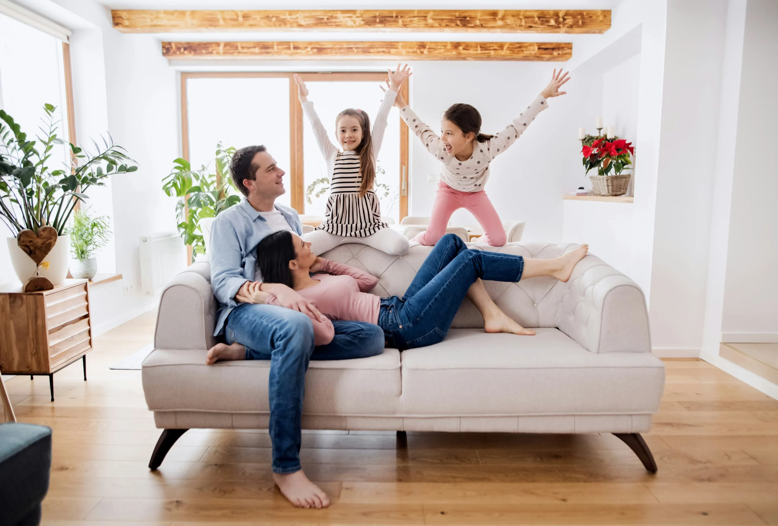 Image of a happy family relaxing on a clean couch in a tidy bright living room
