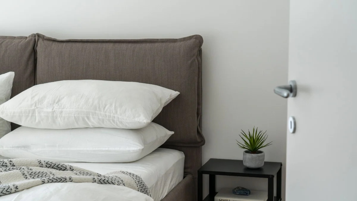 Freshly made bed with white pillows in a vacation rental bedroom
