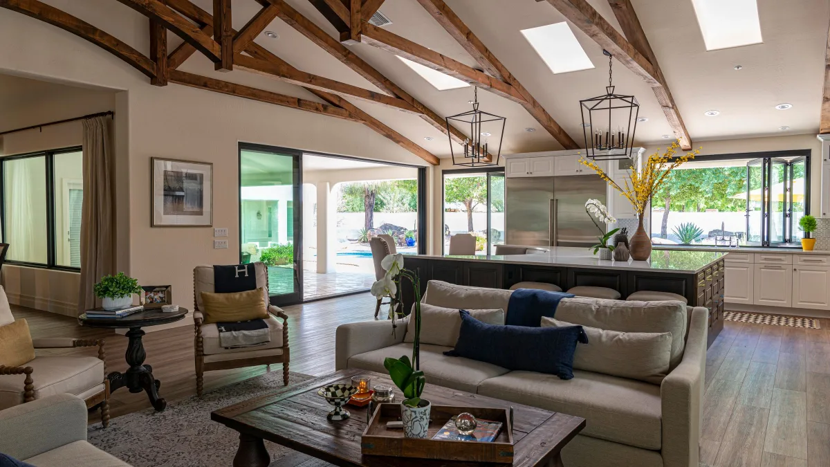 Spacious living room with exposed beams and large windows