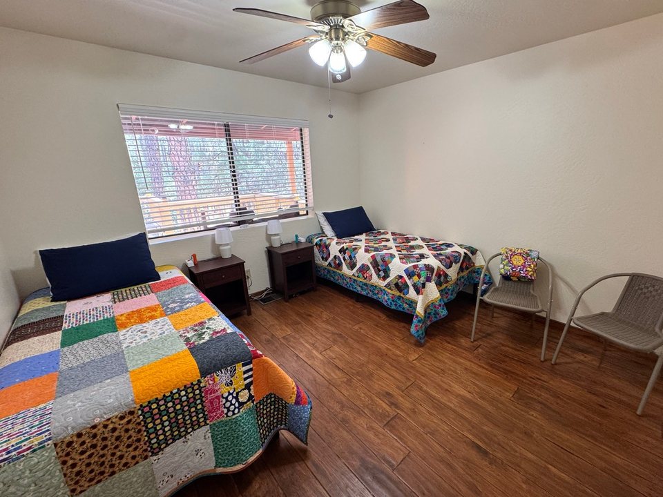 Same bedroom with both beds made with quilts after a cleaning in Pine, AZ