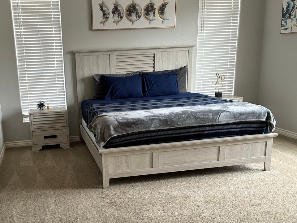 Same bedroom with the bed made and vacuum lines in the carpet after a cleaning in Williams, AZ