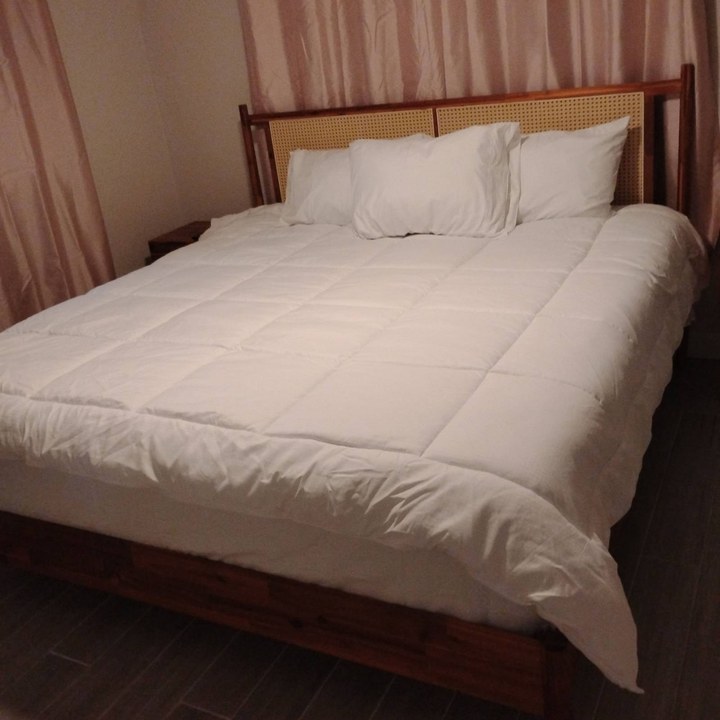 Same bed made with fresh white bedding after cleaning in Scottsdale, AZ