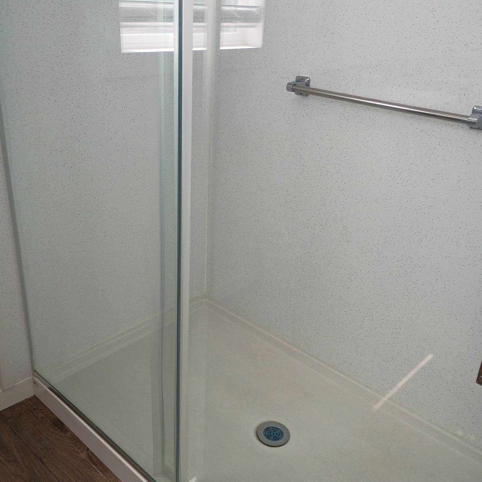 Clean glass shower with a white shower base in a Camp Verde, AZ bathroom