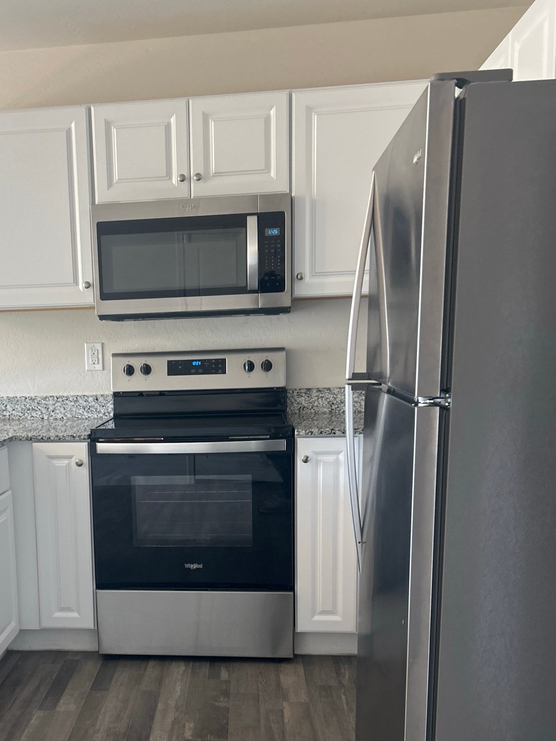 Clean kitchen with a stainless range, microwave and refrigerator after a house cleaning in Casa Grande, AZ