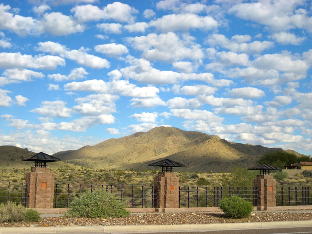 Daisy Mountain behind a stone and iron wall in Anthem, Arizona