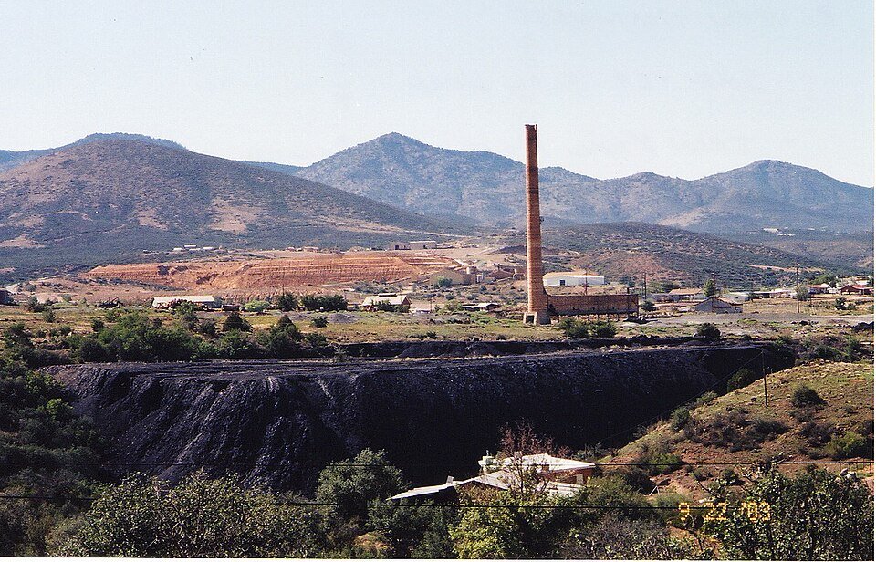 Old Humboldt smelter smokestack and slag pile with mountains behind in Dewey-Humboldt, Arizona