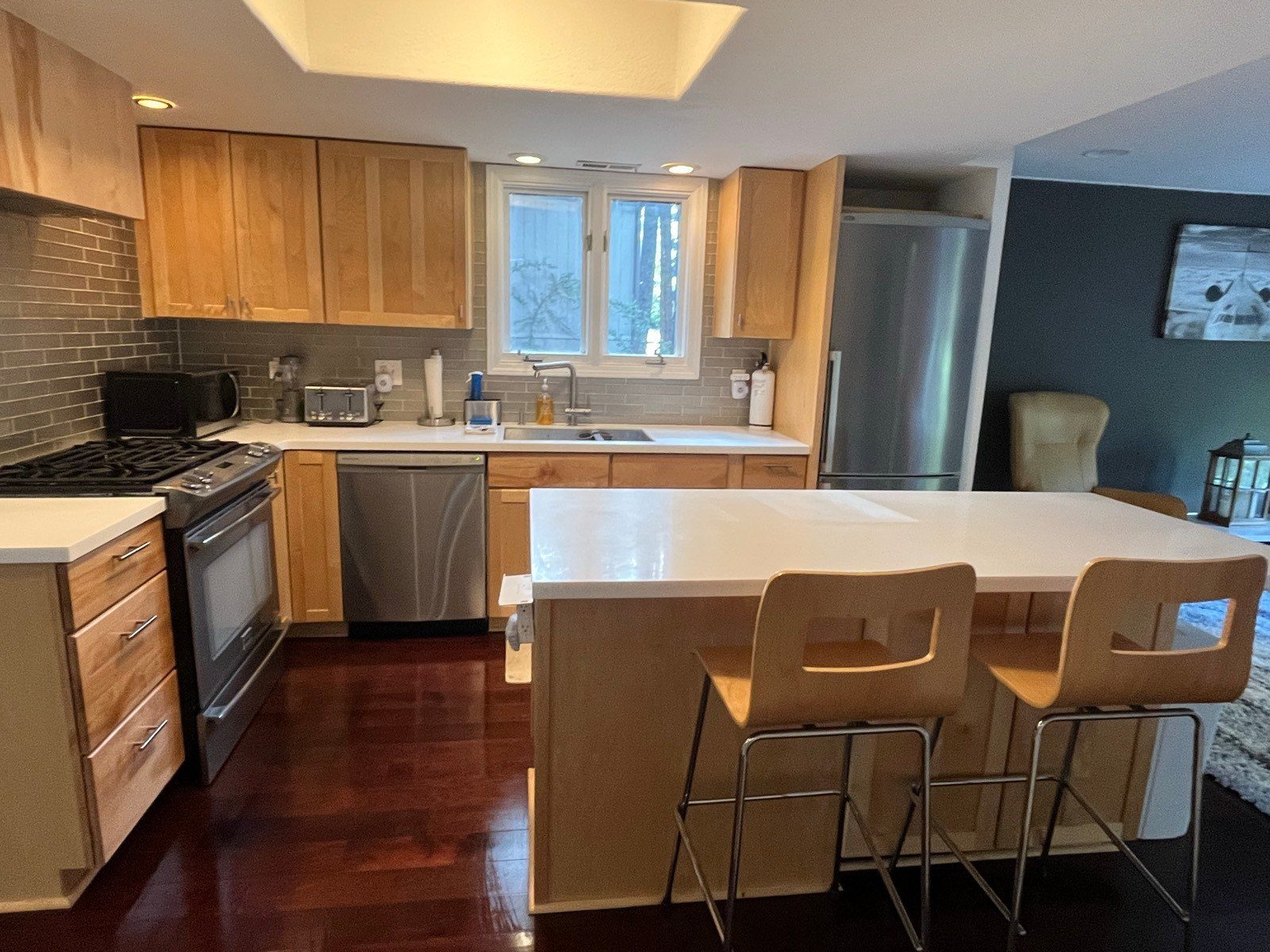 Clean kitchen island, white counters and stainless appliances after a house cleaning in Flagstaff, AZ