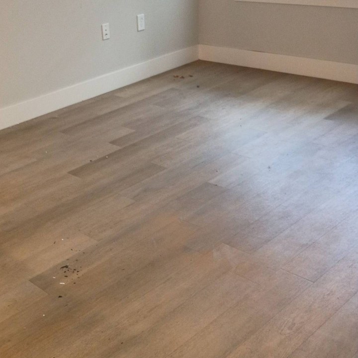 Dusty plank floor with dirt and debris before a cleaning in Goodyear, AZ