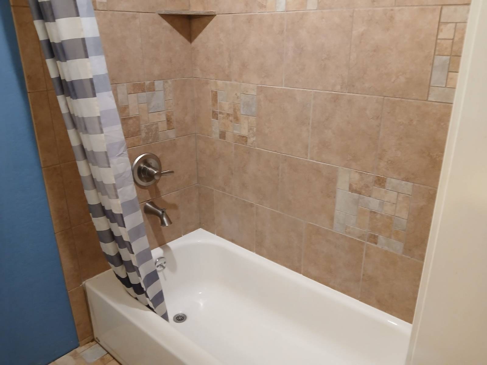 Clean white bathtub and tile shower surround after a cleaning in Dewey-Humboldt, AZ