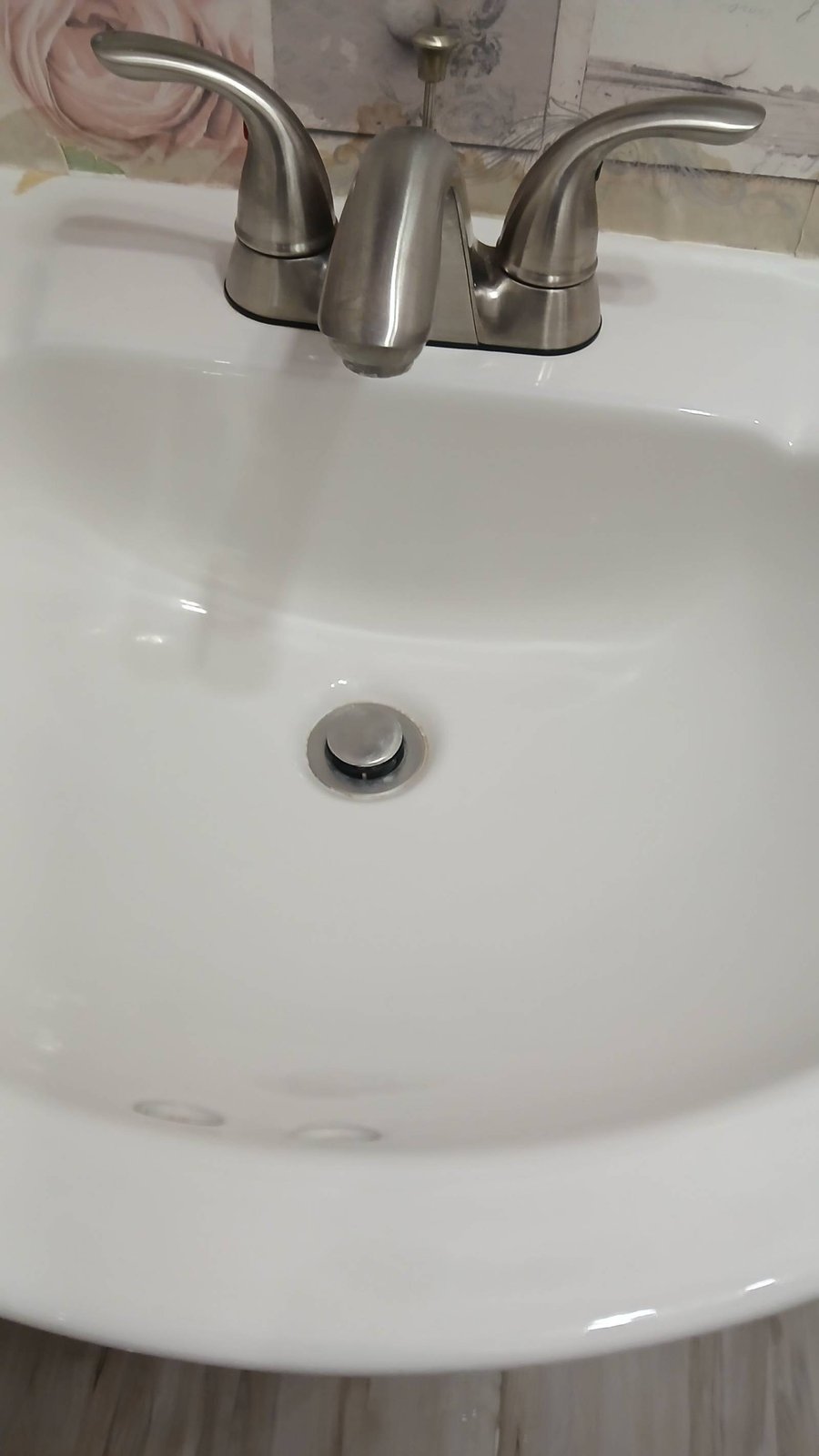 Clean white pedestal sink and brushed nickel faucet in Show Low, AZ