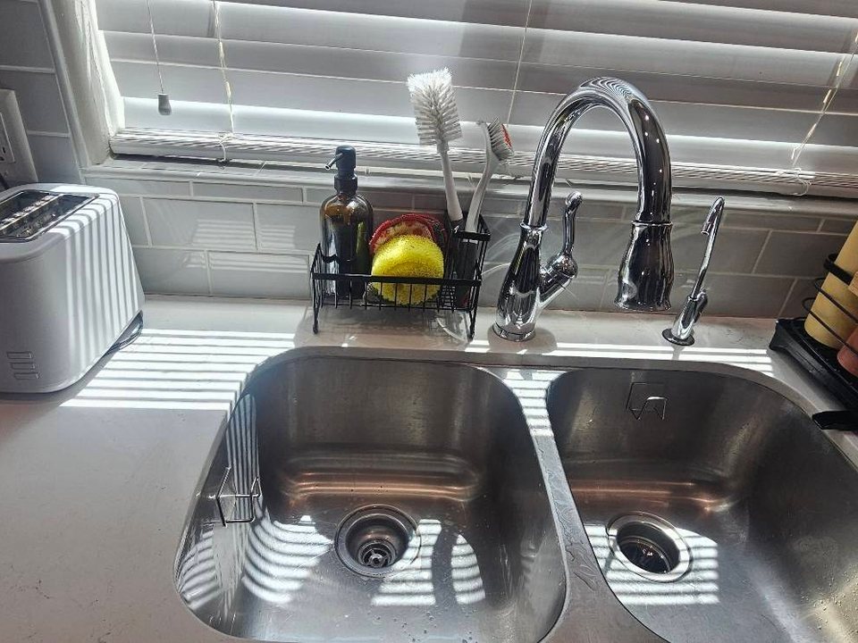 Same kitchen sink empty and clean after a cleaning in Yuma, AZ