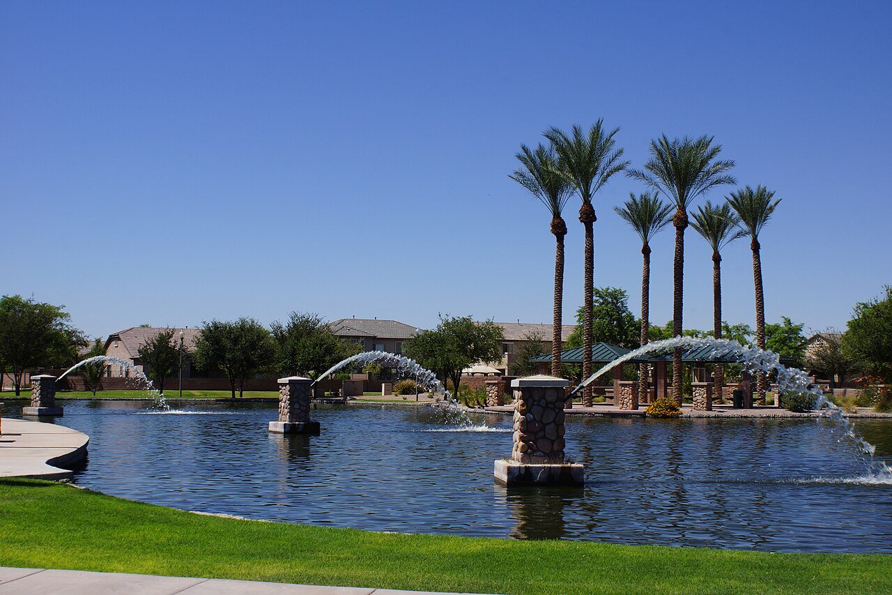 Pond with fountains and tall palm trees in Maricopa, Arizona