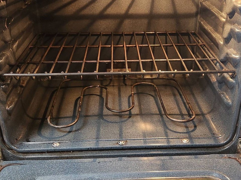 Same oven with a clean floor and interior after a cleaning in Tucson, AZ
