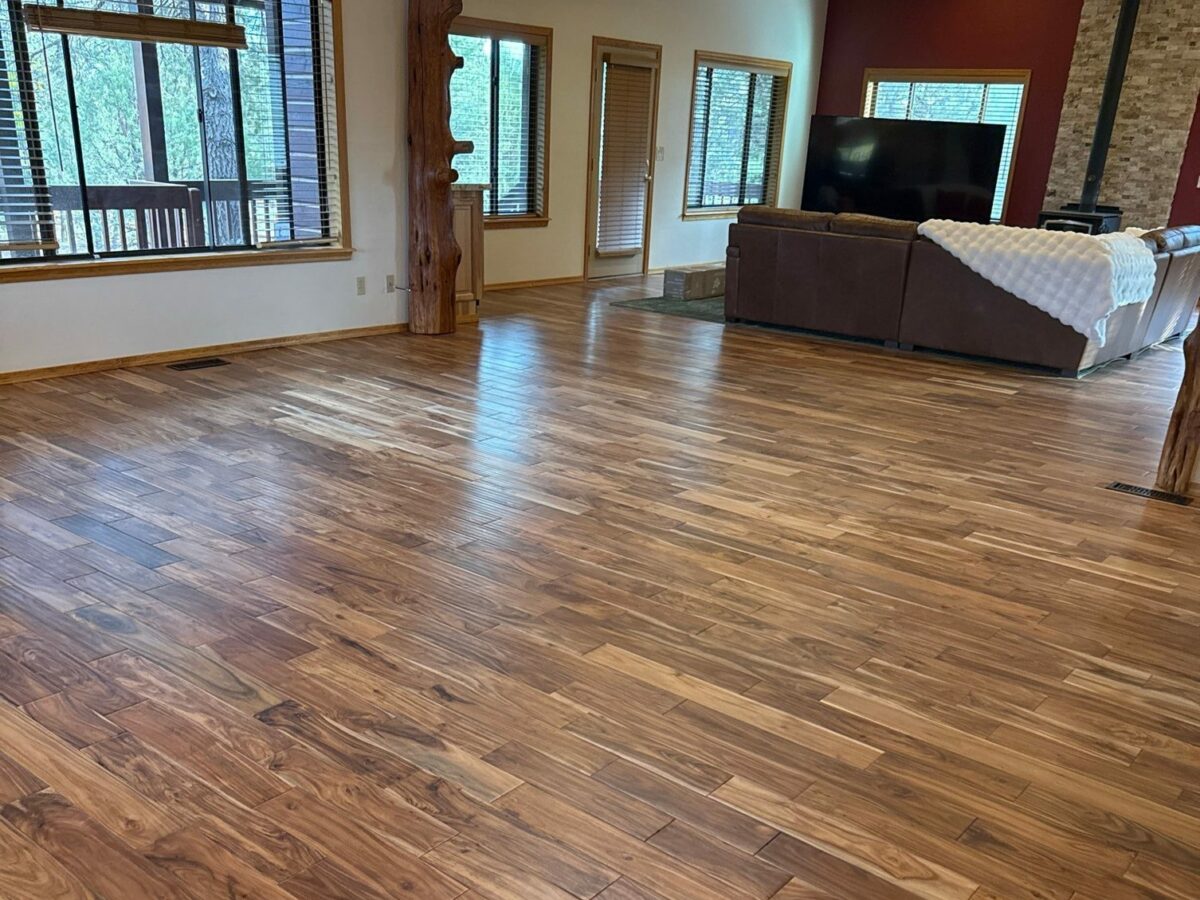 Open living room with clean, shiny hardwood floors after a cleaning in Overgaard, AZ