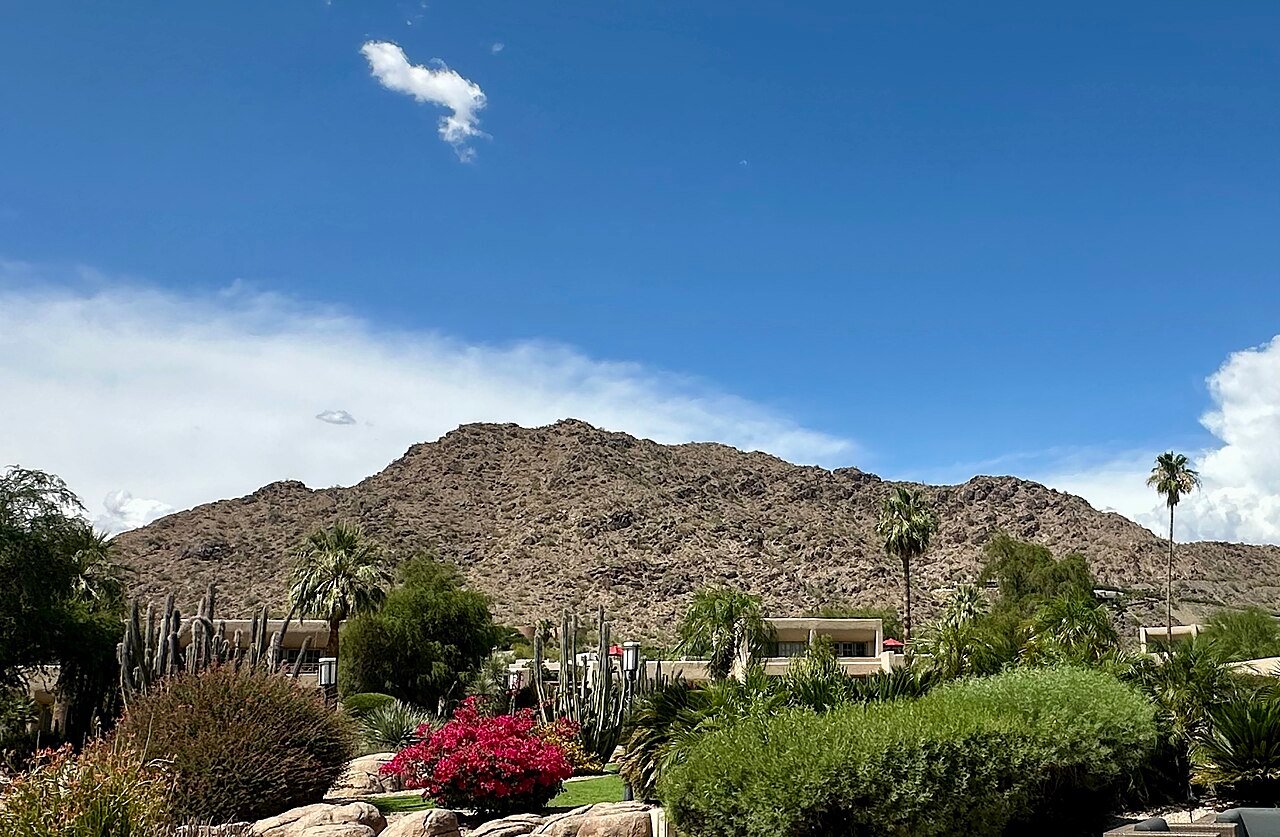 Mummy Mountain above desert landscaping and palm trees in Paradise Valley, Arizona