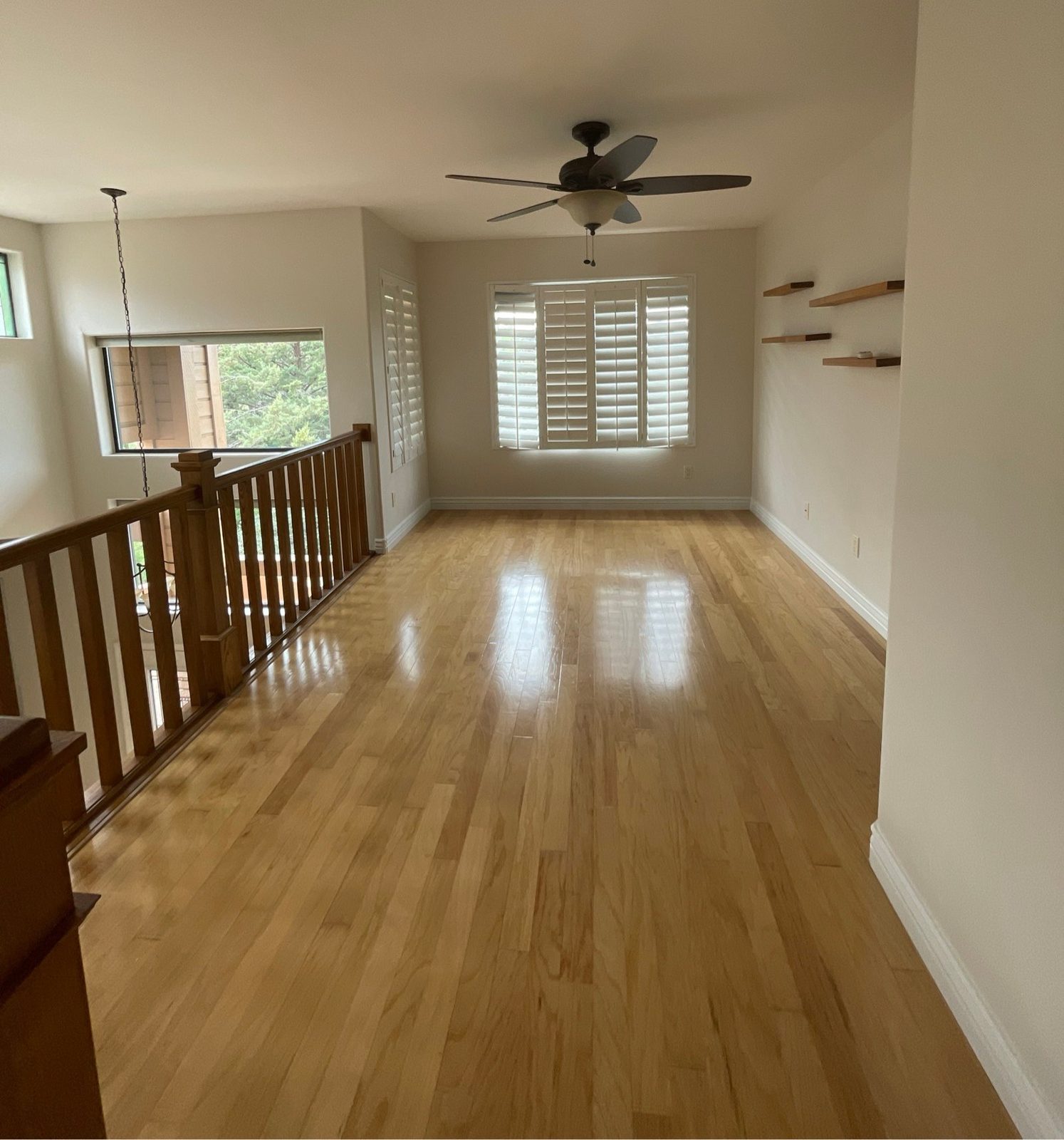 Bright upstairs loft with clean, shiny hardwood floors after a cleaning in Prescott, AZ