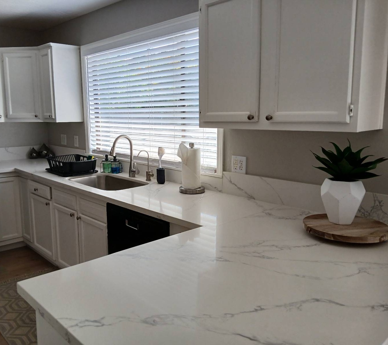 Clean white kitchen with marble-look countertops after a house cleaning in Prescott Valley, AZ