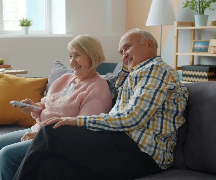 Retired couple relaxing at home after a house cleaning