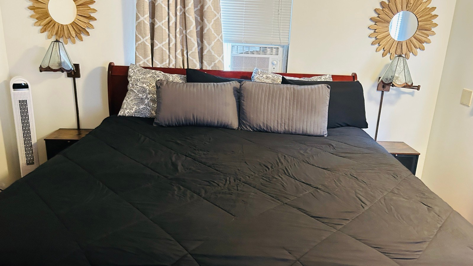 Freshly made king bed with a black comforter after a cleaning in Sedona, AZ