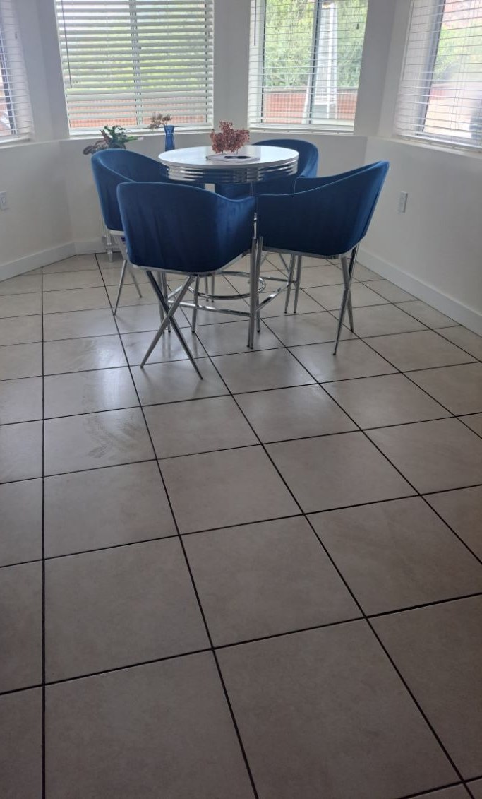 Bright dining nook with blue chairs and clean tile floor after a house cleaning in Sedona, AZ