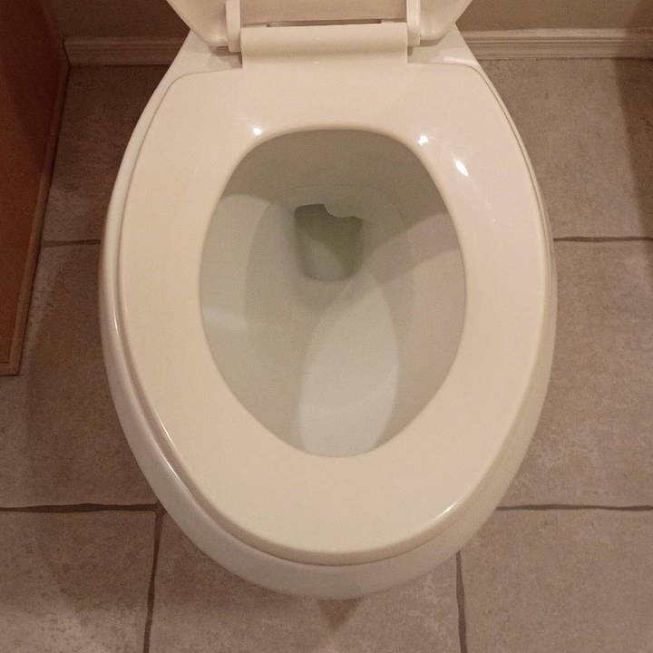 Same toilet with a clean bowl and floor after cleaning in Anthem, AZ