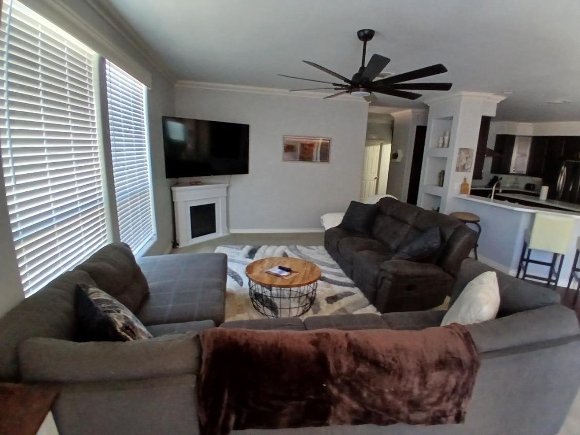 Living room with gray sofas, a round coffee table and open blinds after a cleaning in Williams, AZ