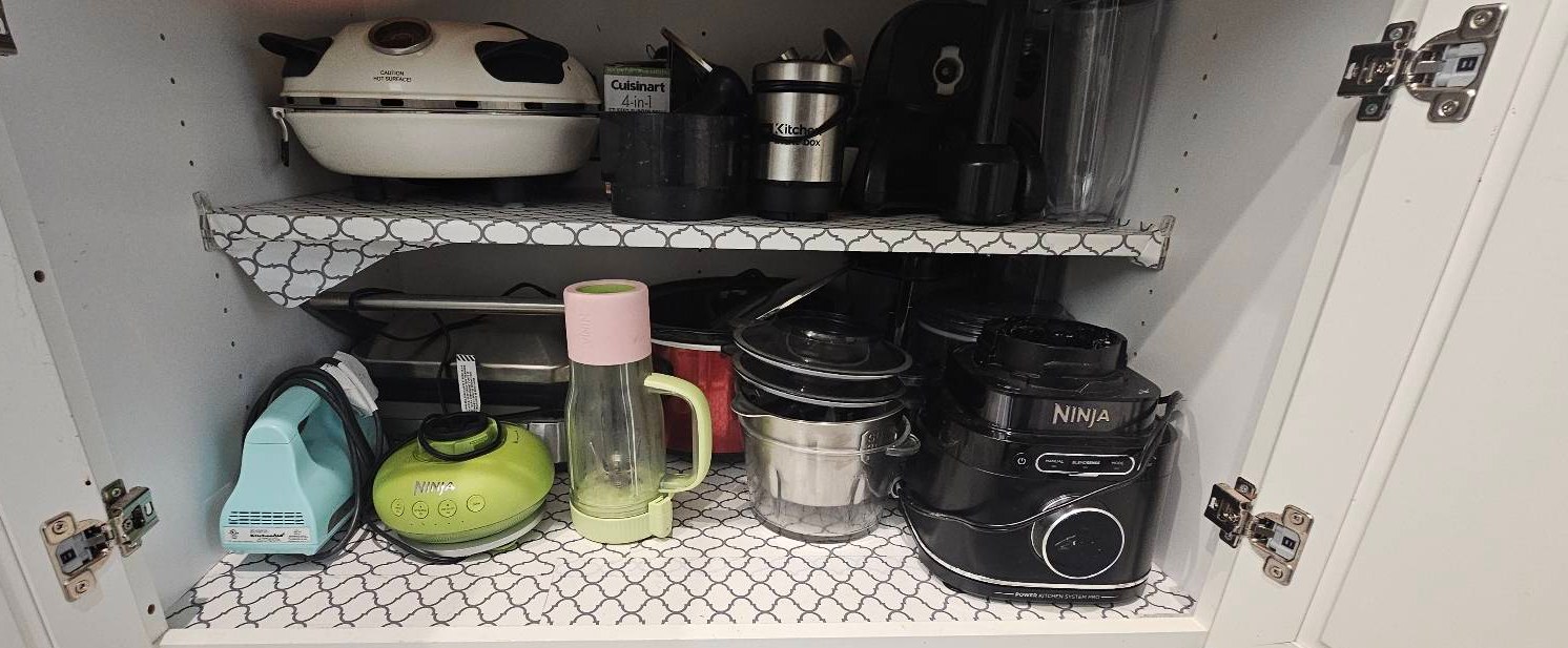 Kitchen cabinet with small appliances neatly arranged after a home organization service in Yuma, AZ